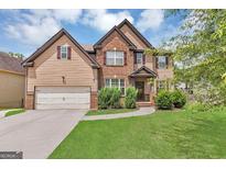 Charming two-story home with a brick and siding facade, manicured lawn, and inviting curb appeal at 2619 Dayview, Atlanta, GA 30331