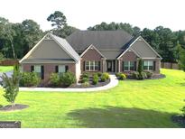 Charming brick home with well-manicured lawn and landscaping for great curb appeal at 116 Standford Dr, Mcdonough, GA 30252