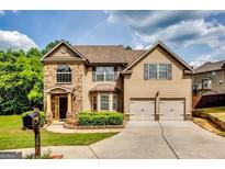 Charming two-story home with a manicured lawn, complemented by a two-car garage and classic brick accents at 697 Chapman, Jonesboro, GA 30238