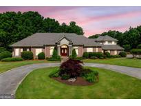 Stately brick home with manicured landscaping and a circular driveway at 226 Euharlee Five Forks Rd, Kingston, GA 30145