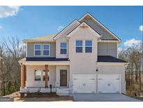 Charming two-story home with a welcoming front porch and a two-car garage, offering curb appeal at 257 Orwell Drive Lot 48 # 48, Social Circle, GA 30025