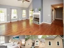 Spacious living room featuring a fireplace, vaulted ceilings, and hardwood floors at 1252 Heritage Dr, Villa Rica, GA 30180