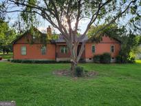 Charming home with a tree-filled yard and inviting front entrance at 45 Oak Wood Lane, Covington, GA 30016