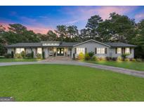 Charming single-story home with well-manicured lawn, stone walkway, and inviting front entrance at 396 Ebenezer Rd, Fayetteville, GA 30215