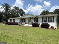 Charming single-story home featuring a well-manicured lawn and classic brick exterior at 4790 Hwy 101 N, Rockmart, GA 30153
