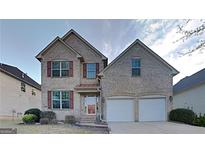 Charming two-story brick home with a two-car garage and manicured front lawn at 5598 Jamerson Dr, Atlanta, GA 30349