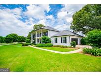 Sprawling two-story home with a manicured lawn and side-entry garage at 1074 Glenloch Rd, Roopville, GA 30170