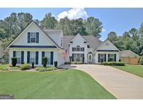 Charming two-story home with well-manicured lawn and inviting curb appeal at 155 Westminister Village Blvd, Sharpsburg, GA 30277