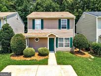 Charming two-story home features a well-maintained lawn, green shutters, and a welcoming front entrance at 134 Watercress Ct, Stockbridge, GA 30281