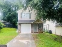 Charming two-story home with a single-car garage and well-maintained front yard at 3523 Lehigh Way, Decatur, GA 30034