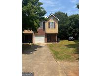 Charming two-story townhome with brick and siding and a convenient attached one car garage at 755 Magnolia Gardens Walk, Mcdonough, GA 30253
