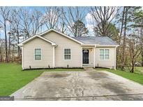 Charming single-story home with a well-maintained front yard and a concrete driveway at 9107 Morris Sw Dr, Covington, GA 30014