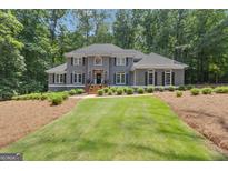Stately two-story home with manicured lawn and mature trees at 425 Birkdale Dr, Fayetteville, GA 30215