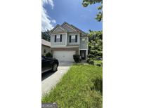 Charming two-story home with neutral siding, black shutters and a two car garage in a suburban neighborhood at 5753 Barrington Run # 114, Union City, GA 30291