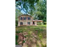 Charming two-story home with a well-maintained lawn and mature trees at 491 Allana Ct, Stone Mountain, GA 30087