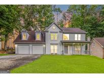 Charming two-story home with a welcoming front porch and three-car garage at 539 Riverbirch Trce, Stone Mountain, GA 30087