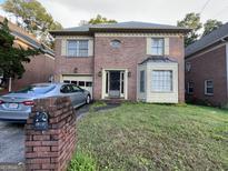 Charming brick home with a well-manicured lawn and attached garage at 4355 Hambrick Pl, Stone Mountain, GA 30083