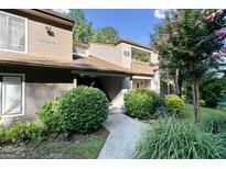 Inviting condo exterior with lush landscaping and private entrance, enhancing curb appeal at 843 Seasons Pkwy, Norcross, GA 30093