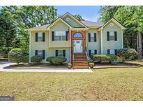 Charming two-story home with a brick-lined entryway and a well-manicured front yard at 85 Eastwood Frst, Covington, GA 30014