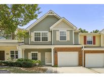 Charming townhome with a one-car garage, landscaped front yard, and a welcoming entrance at 2203 Hyssop Way, Buford, GA 30519