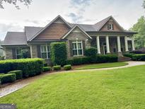 Beautiful brick home with columns, meticulously landscaped yard, and inviting walkway at 7970 Berea Rd, Winston, GA 30187