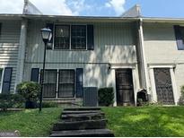 Charming multi-level townhouse with inviting front door, landscaped lawn, and vintage-style streetlamp at 412 Sycamore Dr # D, Decatur, GA 30030