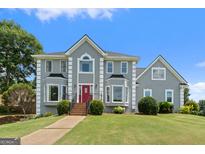 Beautiful two-story home with a red front door and well-manicured lawn at 11 Chad Ct, Mcdonough, GA 30253
