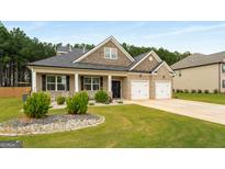 Beautiful brick home features a manicured lawn and attached two car garage at 845 Graeme Dr, Mcdonough, GA 30252