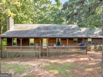 Charming single story house featuring a covered front porch and mature trees at 1000 Coan Dr, Locust Grove, GA 30248
