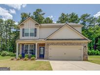 Charming two-story home featuring a brick facade, neutral siding, and a two-car garage at 116 Sophie Cir, Locust Grove, GA 30248