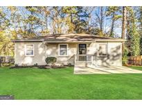 Charming brick home with a well-manicured lawn, inviting entrance, and ample natural light at 3645 Croft Nw Pl, Atlanta, GA 30331