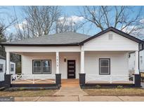 Charming renovated single-story home with white siding, black trim, and a welcoming front porch at 1515 Jonesboro Se Rd, Atlanta, GA 30315