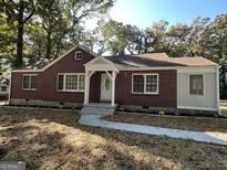 Charming brick home with a newly landscaped yard and a welcoming entrance at 718 N Hairston Rd, Stone Mountain, GA 30083