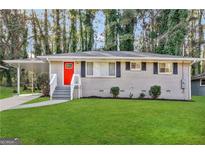 Charming brick home with a bright red door, well-manicured lawn, and inviting curb appeal at 2644 Connally Dr, East Point, GA 30344