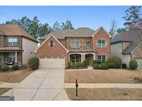 Beautiful two-story brick home with a manicured lawn and attached two-car garage at 2126 Roberts View Trl, Buford, GA 30519