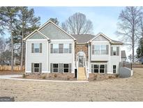 Charming two-story home featuring stone accents, shutters, and a welcoming front porch at 6005 Crowley Dr, Douglasville, GA 30135