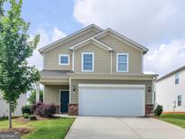 Charming two-story home with a two-car garage, manicured lawn and inviting curb appeal at 505 Mariposa Ln, Mcdonough, GA 30253