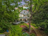Charming two-story home with a sprawling porch and manicured lawn and garden at 53 Born St, Norcross, GA 30071