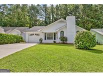 Charming single-story home with a well-maintained lawn, attached garage, and mature trees in a desirable neighborhood at 470 Cornwallis Way, Fayetteville, GA 30214