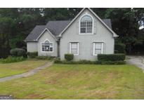 Charming home with a manicured lawn and traditional architectural details at 3336 Harvester Woods Rd, Decatur, GA 30034