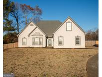 Charming single-story home with a well-maintained lawn and inviting front entrance at 609 Alyssa Ct, Locust Grove, GA 30248