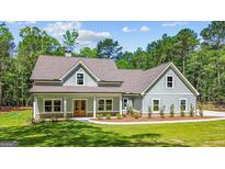 Charming craftsman-style home with a welcoming front porch and beautifully landscaped yard at 4585 Parkwood Rd, Social Circle, GA 30025