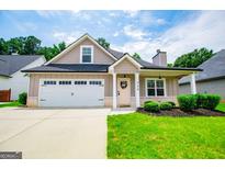 Charming single Gathering home featuring an attached two-car garage and manicured front lawn at 328 Brookstone Dr, Carrollton, GA 30116