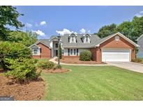 Beautiful single-Gathering home with a well-manicured lawn, brick accents and a two-car garage at 316 Kensington Dr, Peachtree City, GA 30269