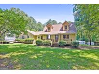 Charming single Gathering home featuring a well-manicured lawn and inviting covered front porch at 292 Selfridge Rd, Mcdonough, GA 30252