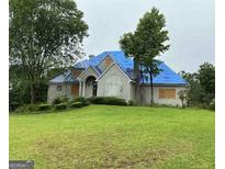 Sprawling two-story home with a covered roof on a large front yard at 145 Windy Ridge Ct, Fayetteville, GA 30214