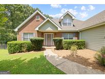 Charming brick home with well-manicured landscaping and a welcoming front entrance with a decorative wreath at 20 Knollwood Pl, Covington, GA 30014