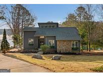 Charming modern home with stone accents and landscaped front yard, perfect for lakeside living at 1190 Plantation Dr, Villa Rica, GA 30180