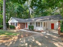 Charming single-story home featuring a brick facade, white siding, and a welcoming red front door at 260 Pinehurst Dr, Stockbridge, GA 30281