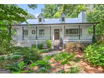 Charming home featuring a welcoming front porch and beautifully landscaped front yard at 3515 Chattahoochee Rd, Cumming, GA 30041